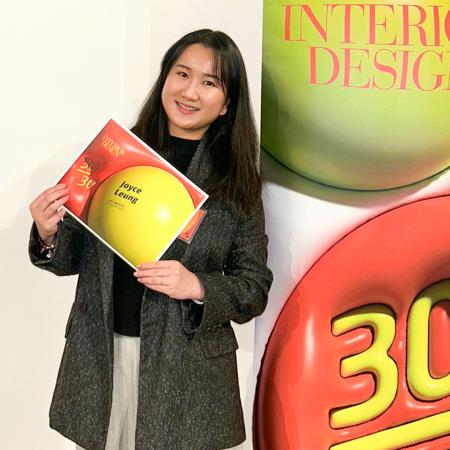 '30/30' design winner Joyce Leung Joyce Leung holds a certificate in front of an Interior Design banner.