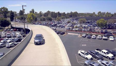 Vehicle driving up parking structure ramp