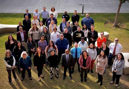 Group photo of the 2024–2025 Data Fellows and Planning Team members standing outdoors on a lawn, smiling and facing the camera