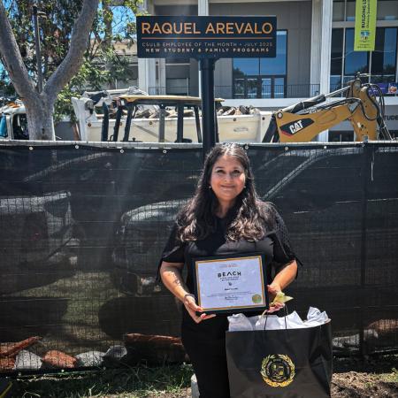 Employee of the Month Raquel Arevalo CSULB employee stands outside holding a certificate and gift bag.