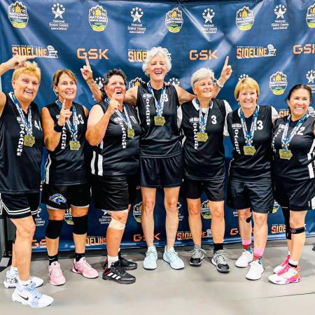 Margaret Mohr ‘88 and Kirsten Cummings ‘85 with teammates Group of women in basketball uniforms pose with medals around their necks