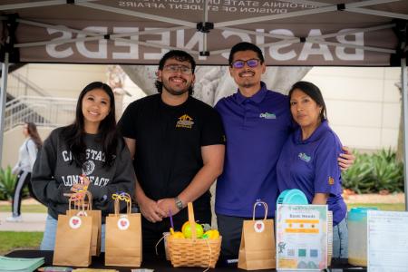 Basic Needs staff smiling at their booth.