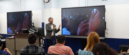 Jose Palacios speaking in a classroom to students