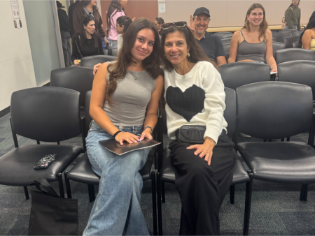Aliya and Roya Valles sit in chairs