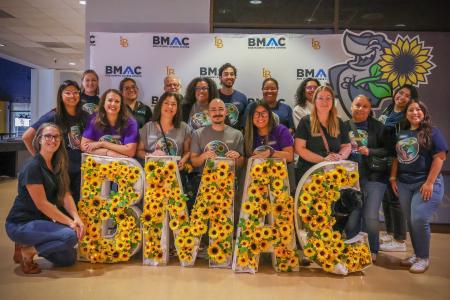 The BMAC team posing for a photo with a BMAC sign.