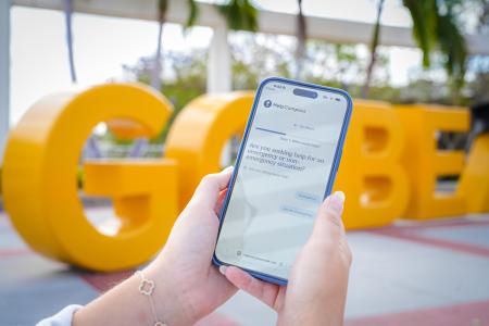 Find Help now app open on a phone in front of the Go Beach sign.