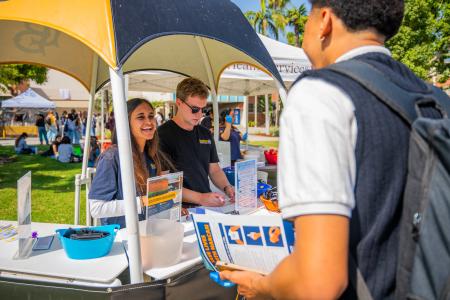 Staff at a booth providing resources to students.