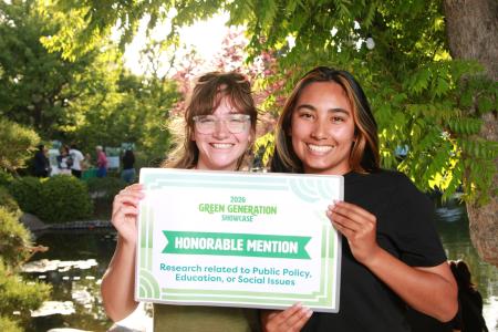 Two students holding an honorable mention sign