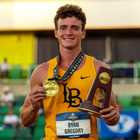 Ryan Gregory holding a medal