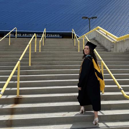 Angelica Faune walks up the steps of the LBS Financial Pyramid