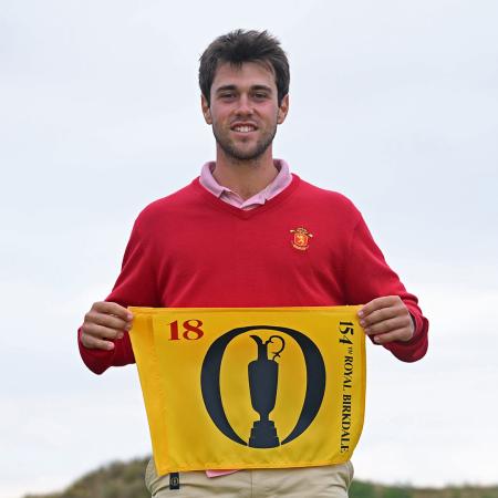 Alejandro de Castro Piera holds a yellow flag that symbolizes the British Open