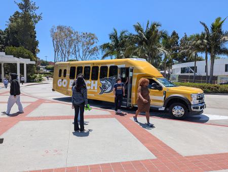 Campus shuttle with students exiting