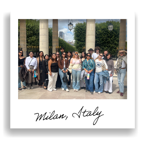 group of people pose together among stone columns