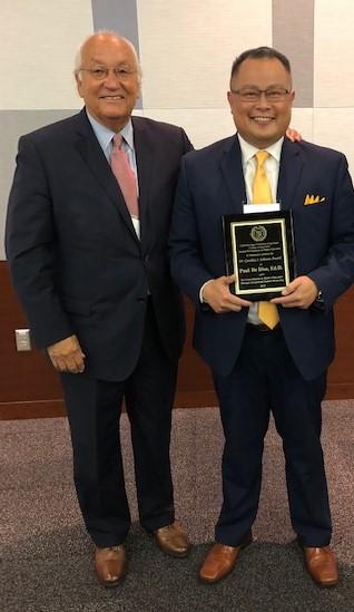 Vega poses with Paul de Dios, now a Cypress College vice president, after presenting de Dios with the Dr. Cynthia S. Johnson Award for Mentoring in 2019. The award recognizes people who’ve mentored student affairs professionals.