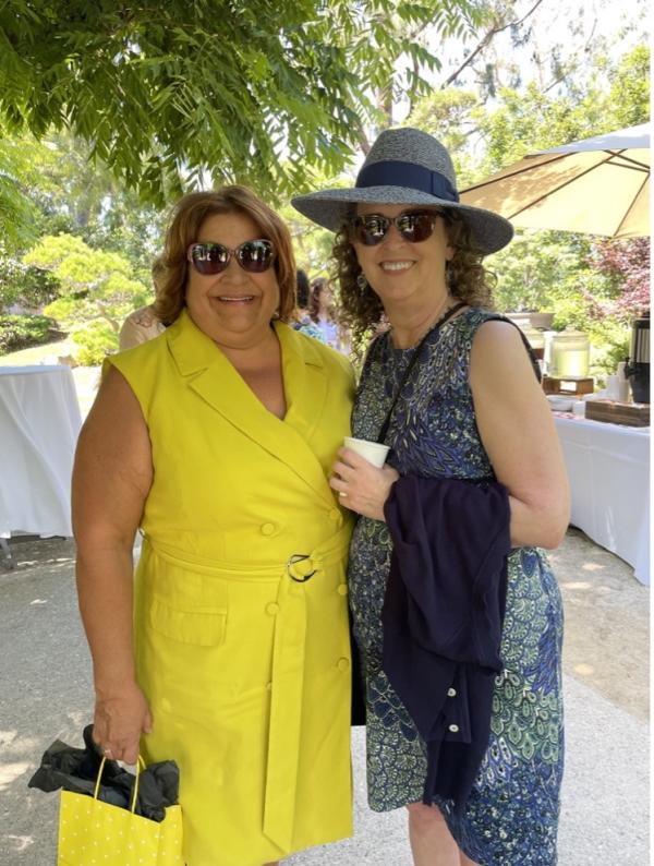 Anna Ortiz and Maryanne Horton pose for a photo under a tree.