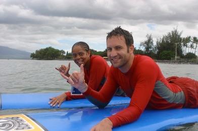 Estella Chiizhik and her husband on surf boards in Hawaii