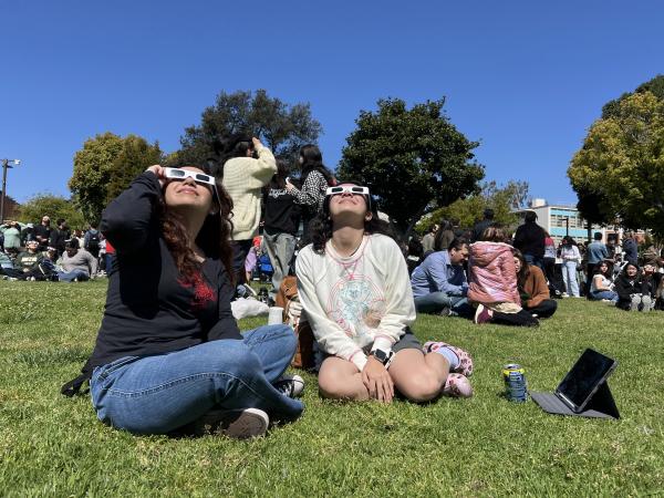 Two CSULB students watch the partial solar eclipse April 8, 20024