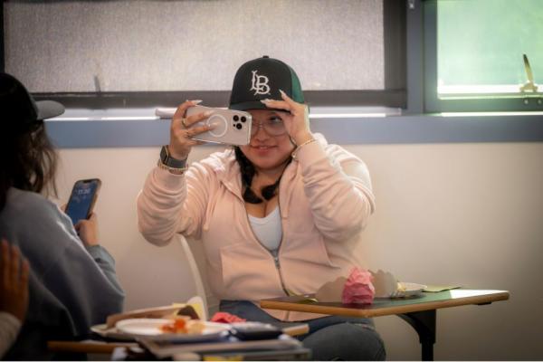 Beach XP Hat Distribution Student taking a selfie with Beach XP hat.