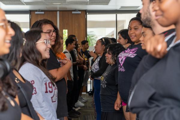 Group of people facing one another at a friendship event.