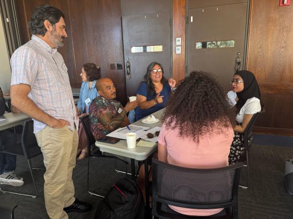 Teacher Jose Rivas, left, listens as educators discuss uses of artificial intelligence in school during a breakout session he led on the topic at the Educators Summit July 25.