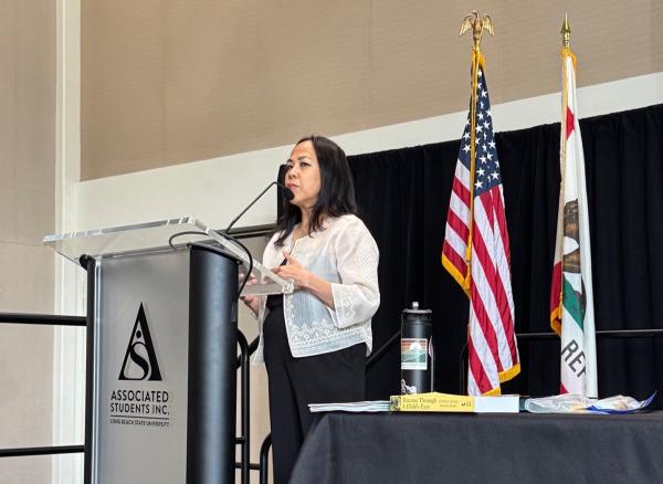 Nichi Avina speaks at a podium during the Educators Summit.