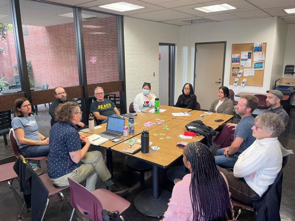 group of people discussing around the table