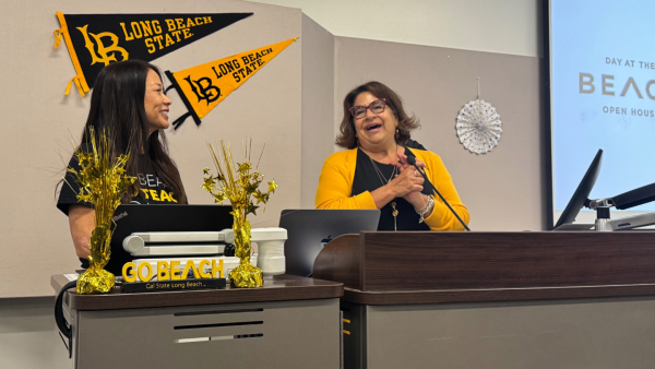 Nat Hansuvadha, chair of the Liberal Studies Department (left), and College of Education Dean Anna Ortiz give a welcome address at Day at The Beach.
