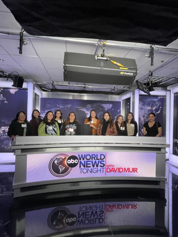 NAHJ members pose behind the "ABC World News" anchor desk in 2024.