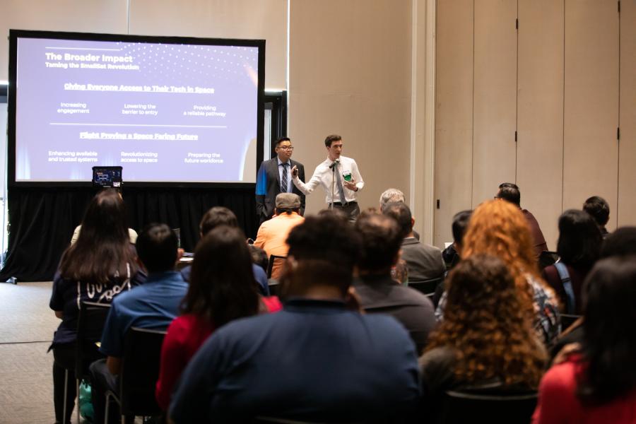 Two students pitching their business idea to an audience