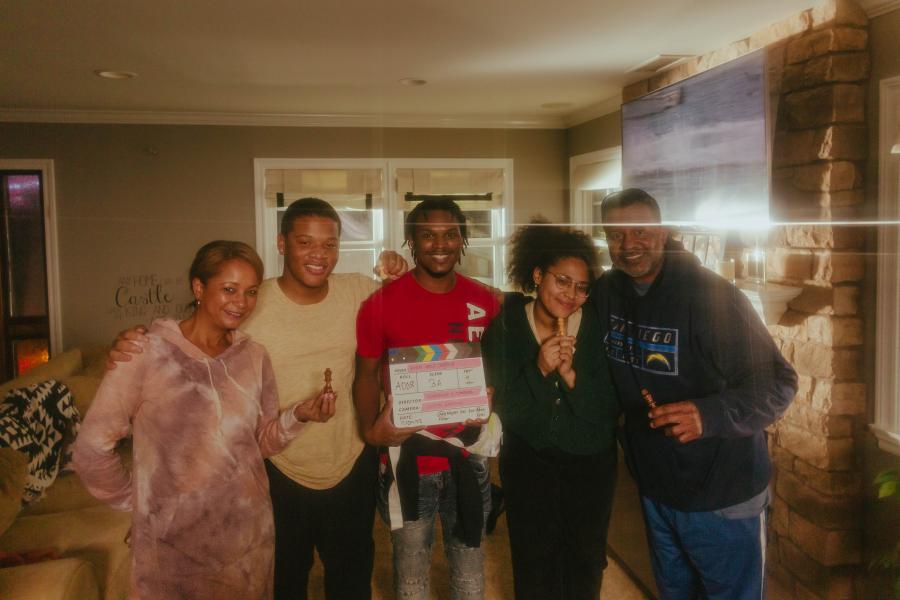Director and actors from "What About Daddy" film stand together on set
