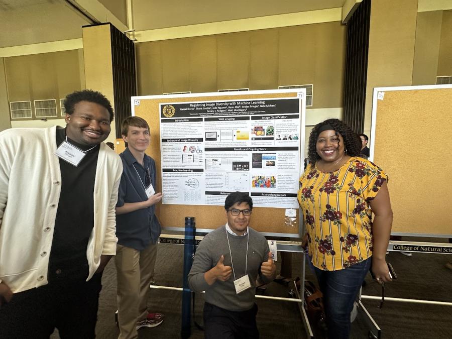 Students and professor pose at a symposium