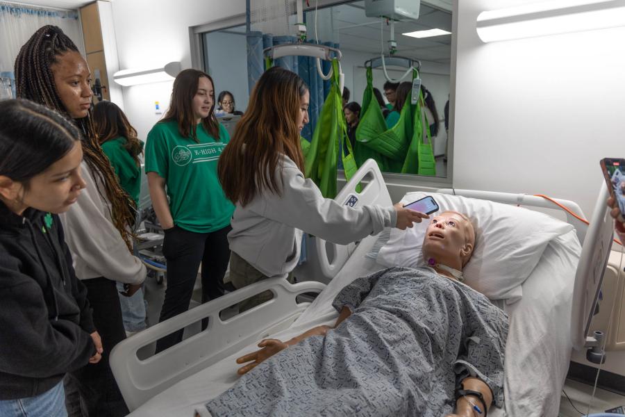 Students inspect a simulation dummy