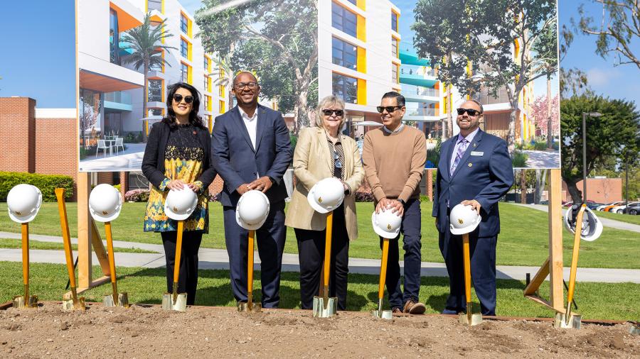 CSULB officials and dignitaries, including Congressman Robert Garcia, pose for a groundbreaking photo at the La Playa dorm site 