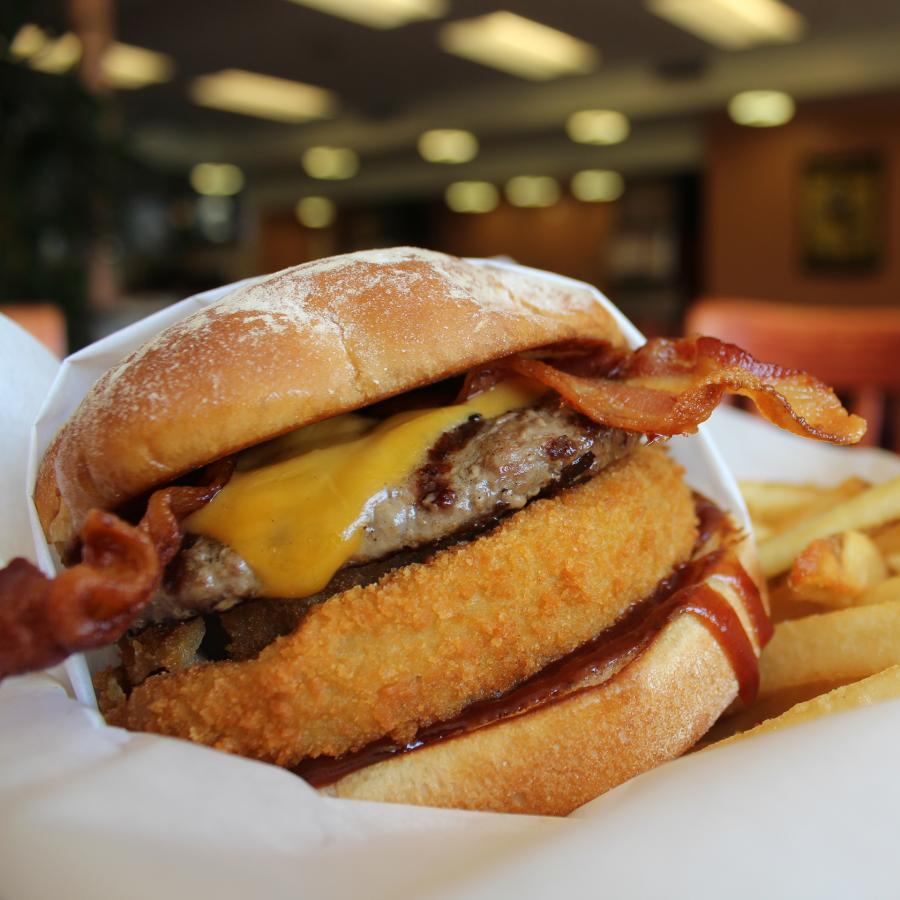 Express Catering Option 3 Closeup of cheeseburger with an onion ring and bacon.