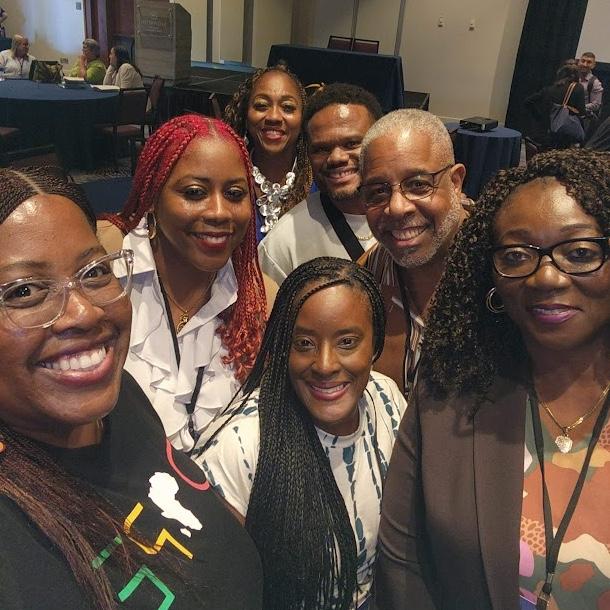 Doctoral students pose for group photo at conference