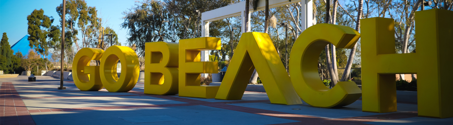Go beach sign with pyramid banner CSULB "go beach" sign on campus with pyramid in background