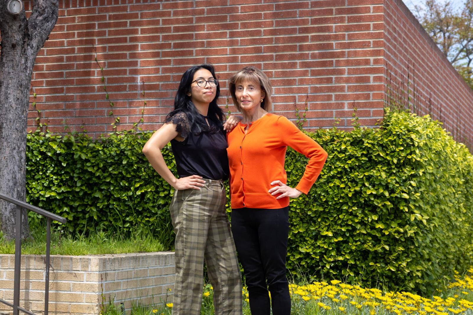 Two women standing in front of building