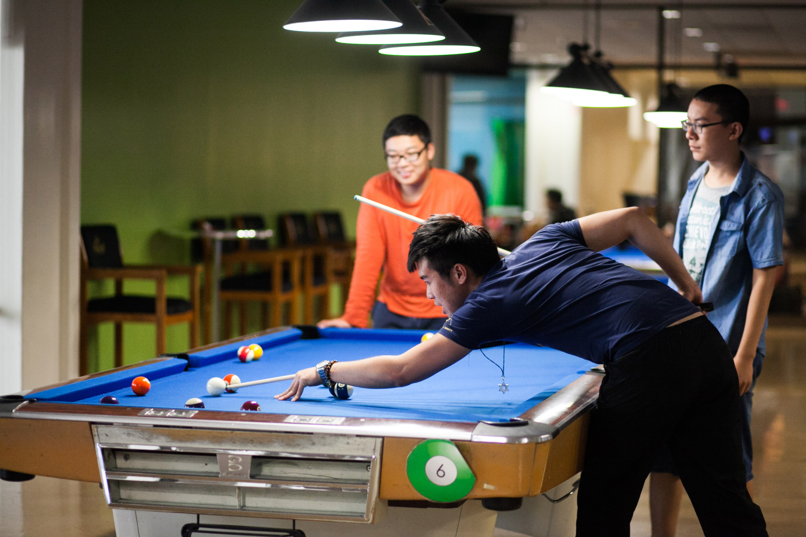 Students playing pool at the Games Center