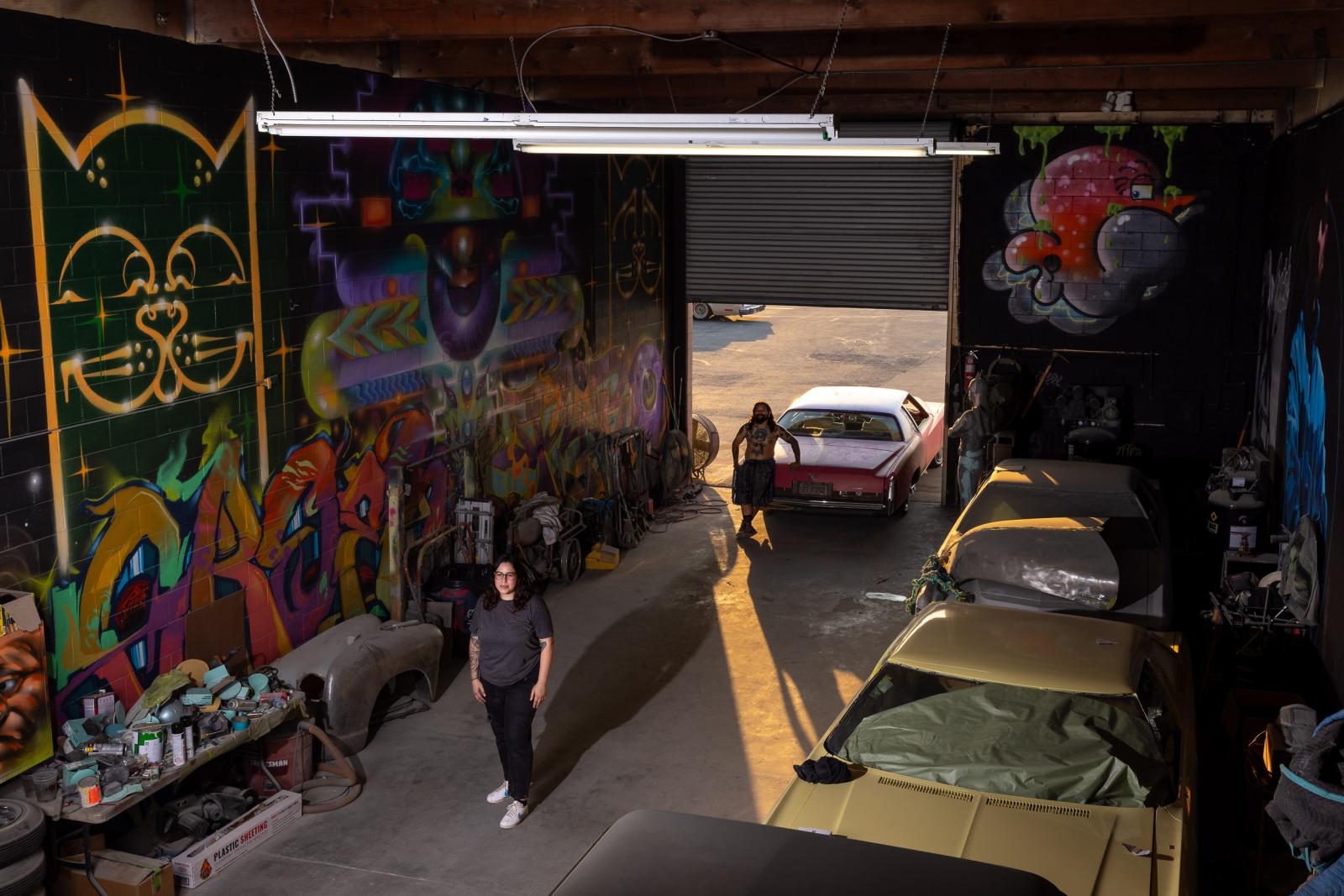 Jacqueline Valenzuela, front, and her fiance in their auto body shop