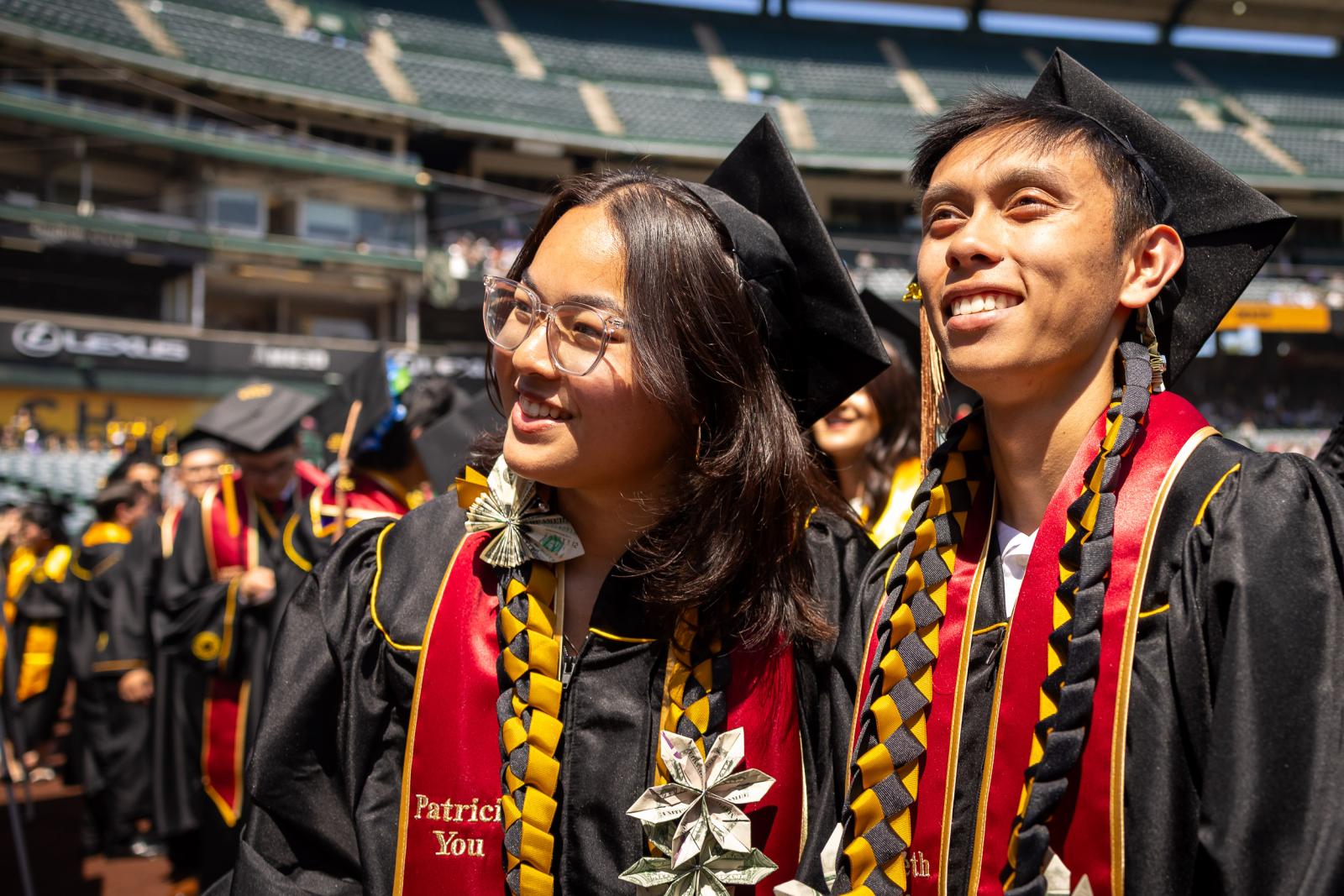 Woman and man graduates at Commencement