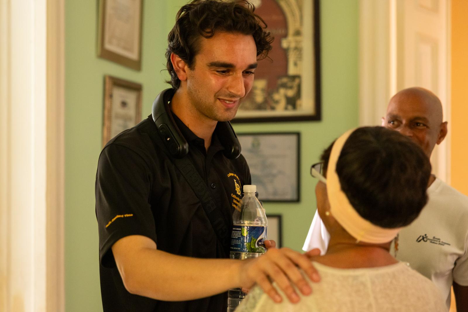 Alexander "Ace" Homami talks with a woman from the Cuba National Choir