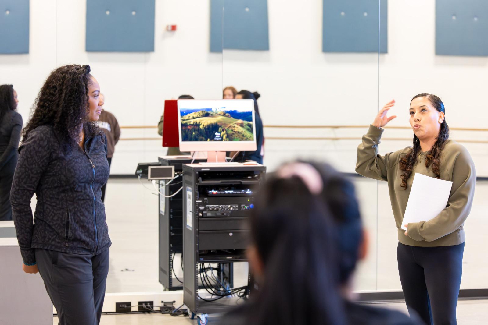 Zakiya Atkinson, left, helps lead a CSULB dance class