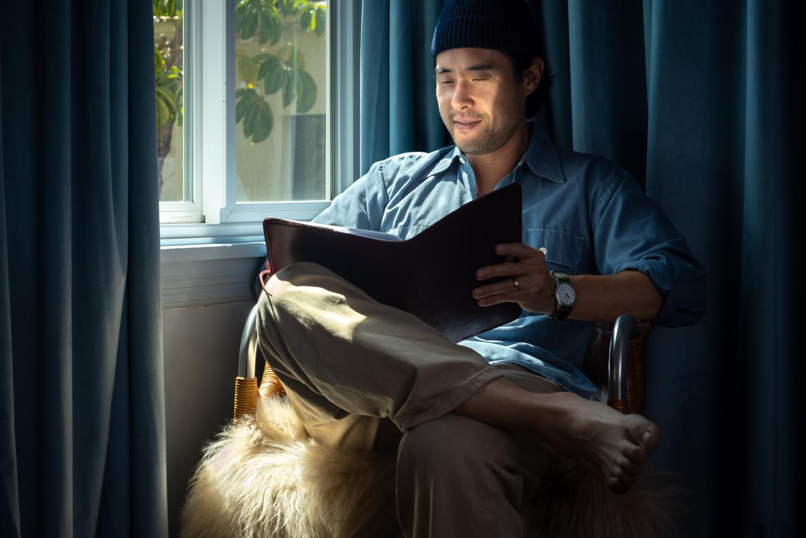 Raymond Lee '08 sits and reads a script