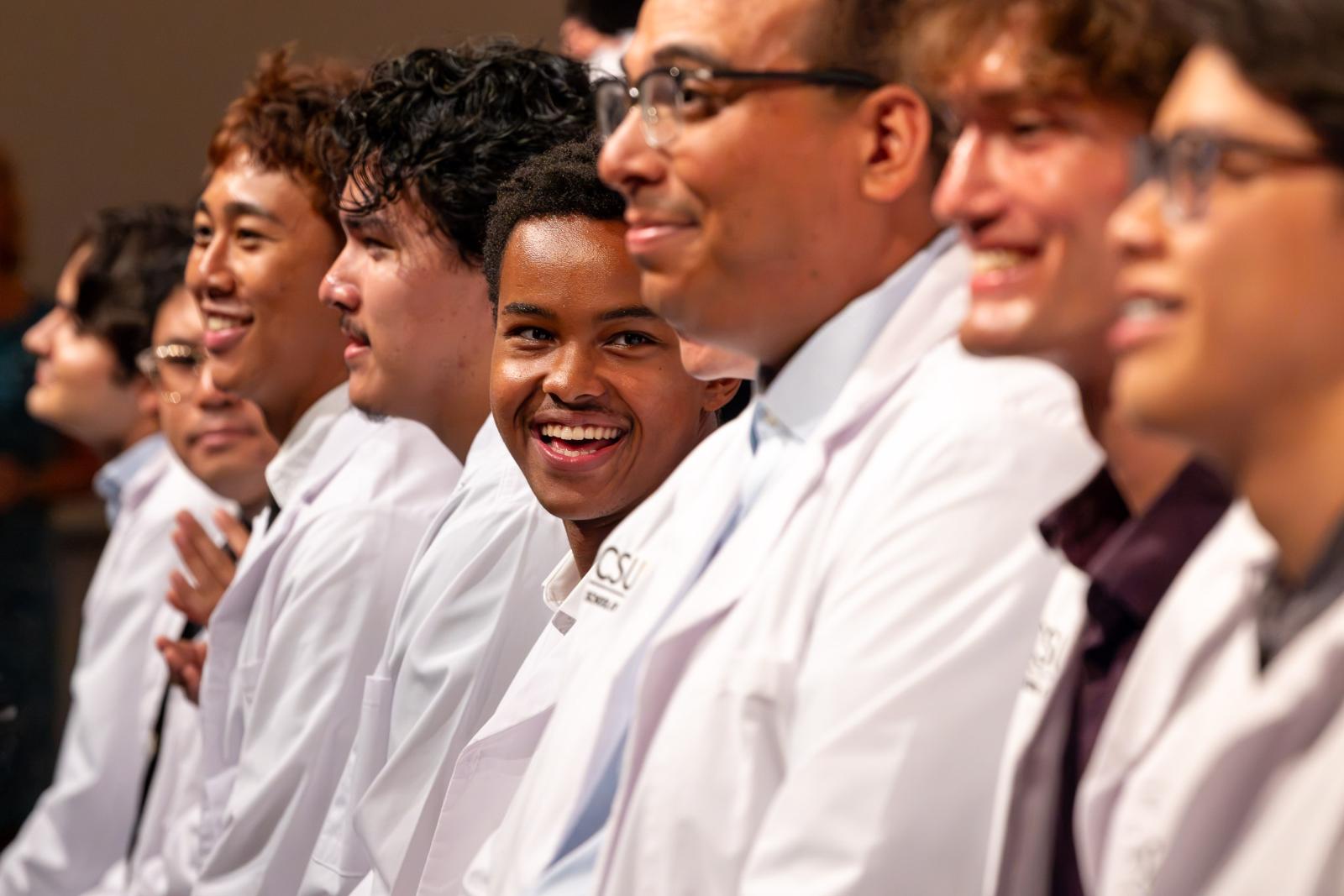 Students smiling during the 2026 White Coat Ceremony