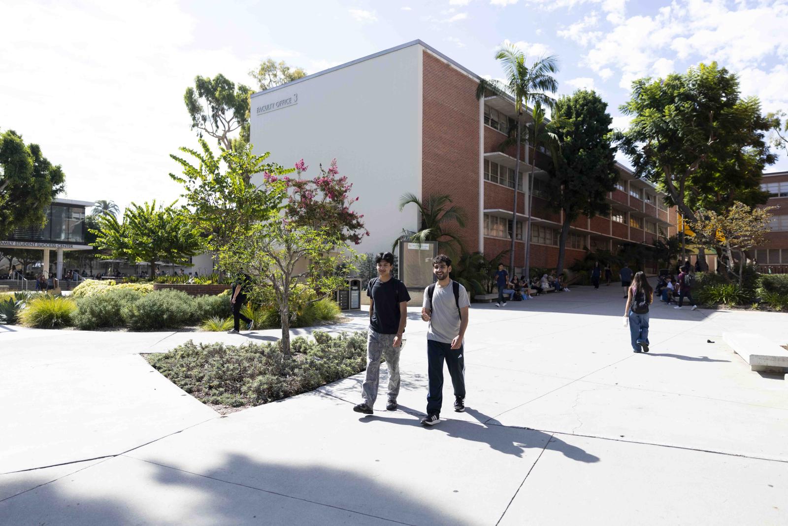 Two students walk in front of Faculty Office 3