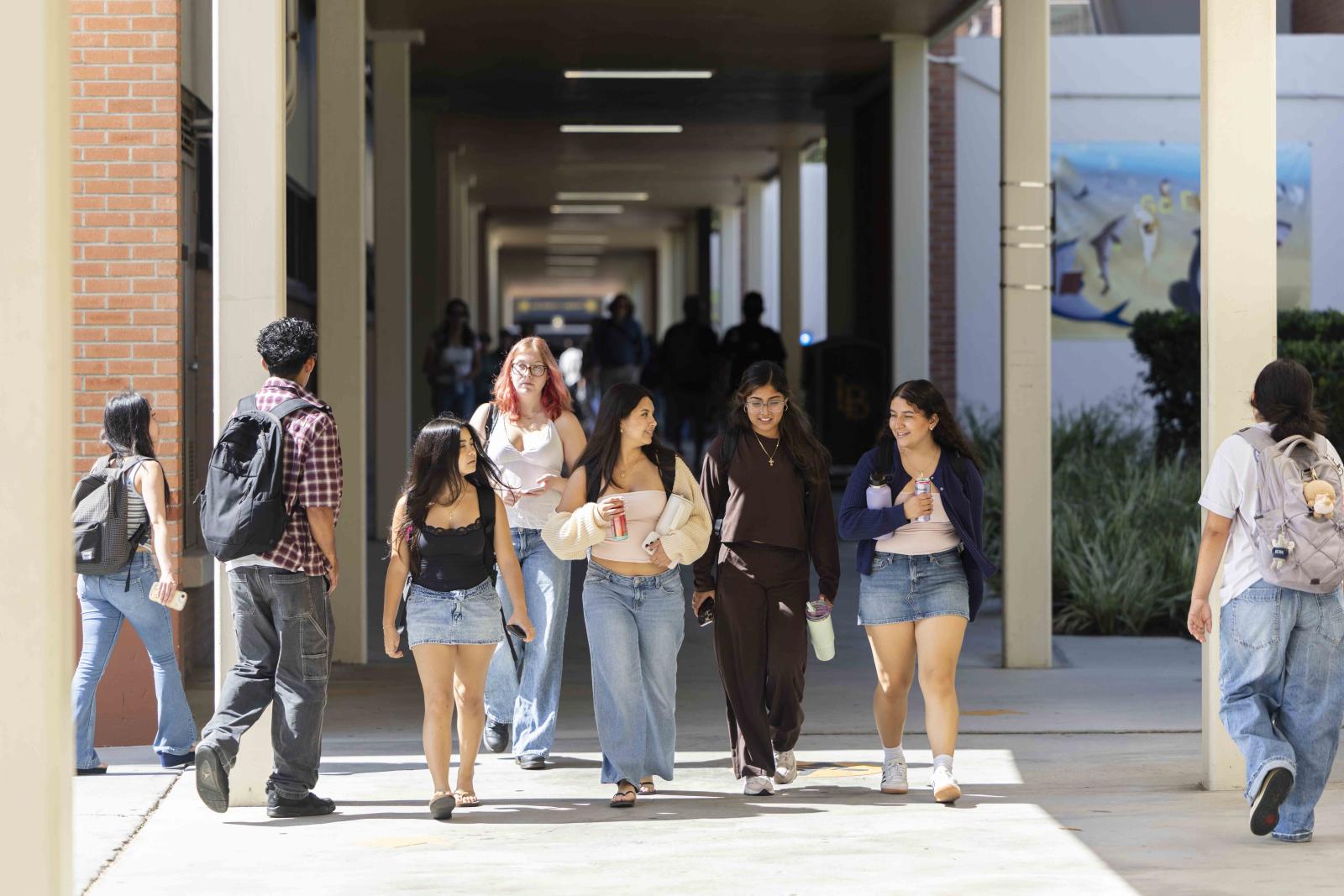 Students walking down a hall between buildings