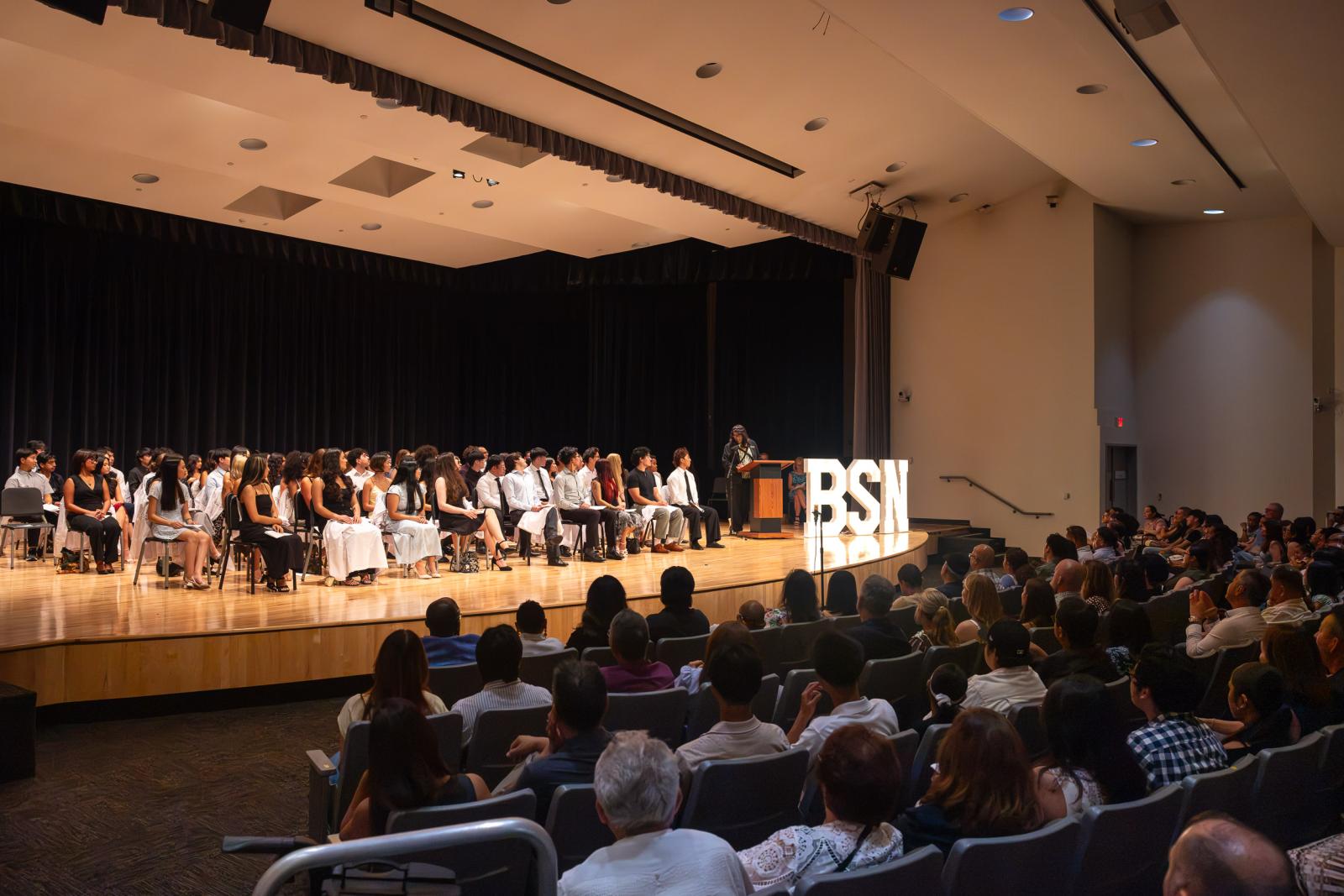 College of Health and Human Services Dean Jennifer Wade-Berg, right, speaks at the 2026 White Coat Ceremony