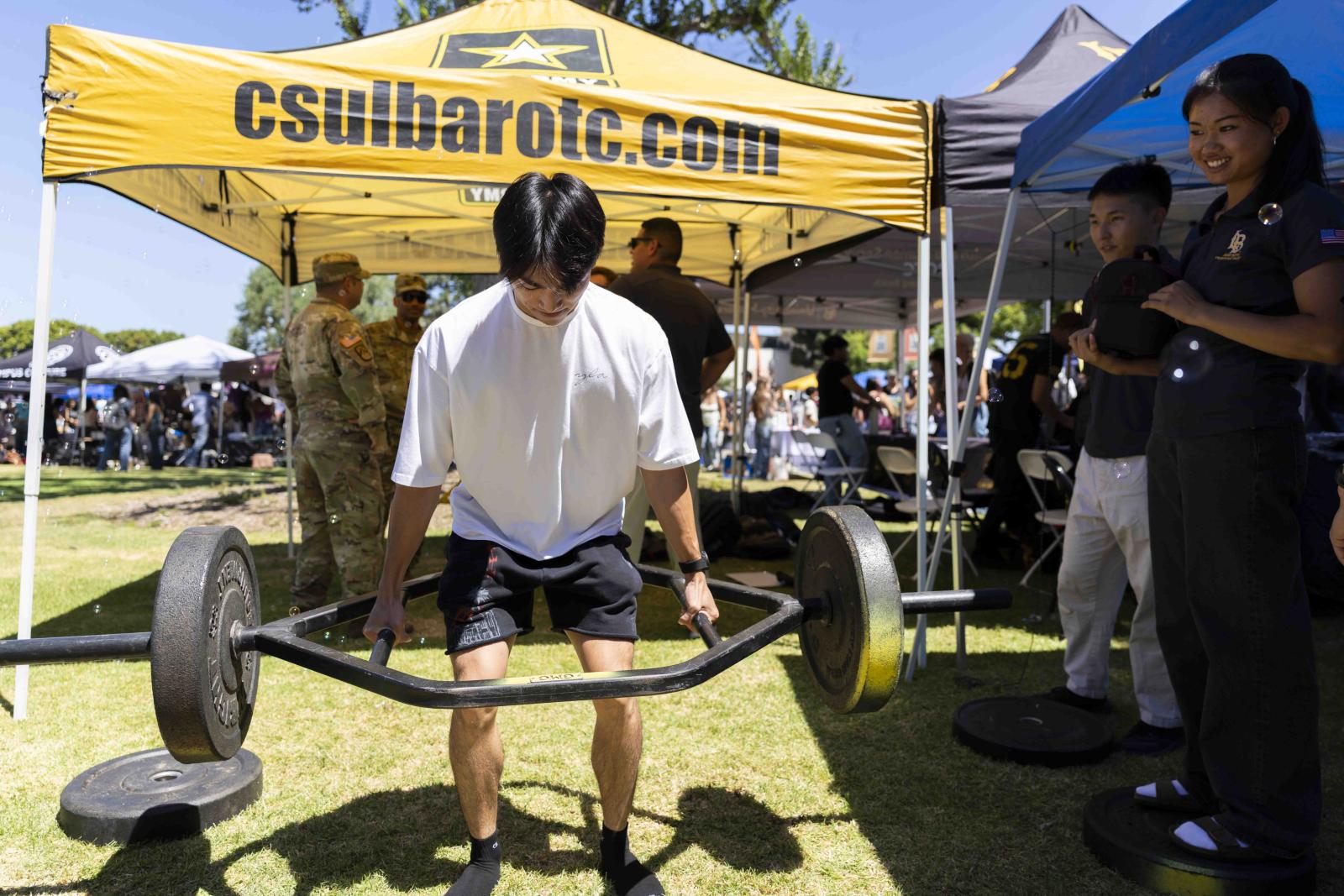 A student lifts weights during Week of Welcome