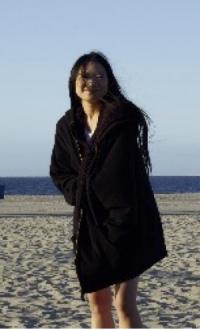 person on the beach in a coat