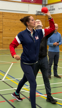 Dr. Melissa Bittner teaching a blind student to overhand throw.